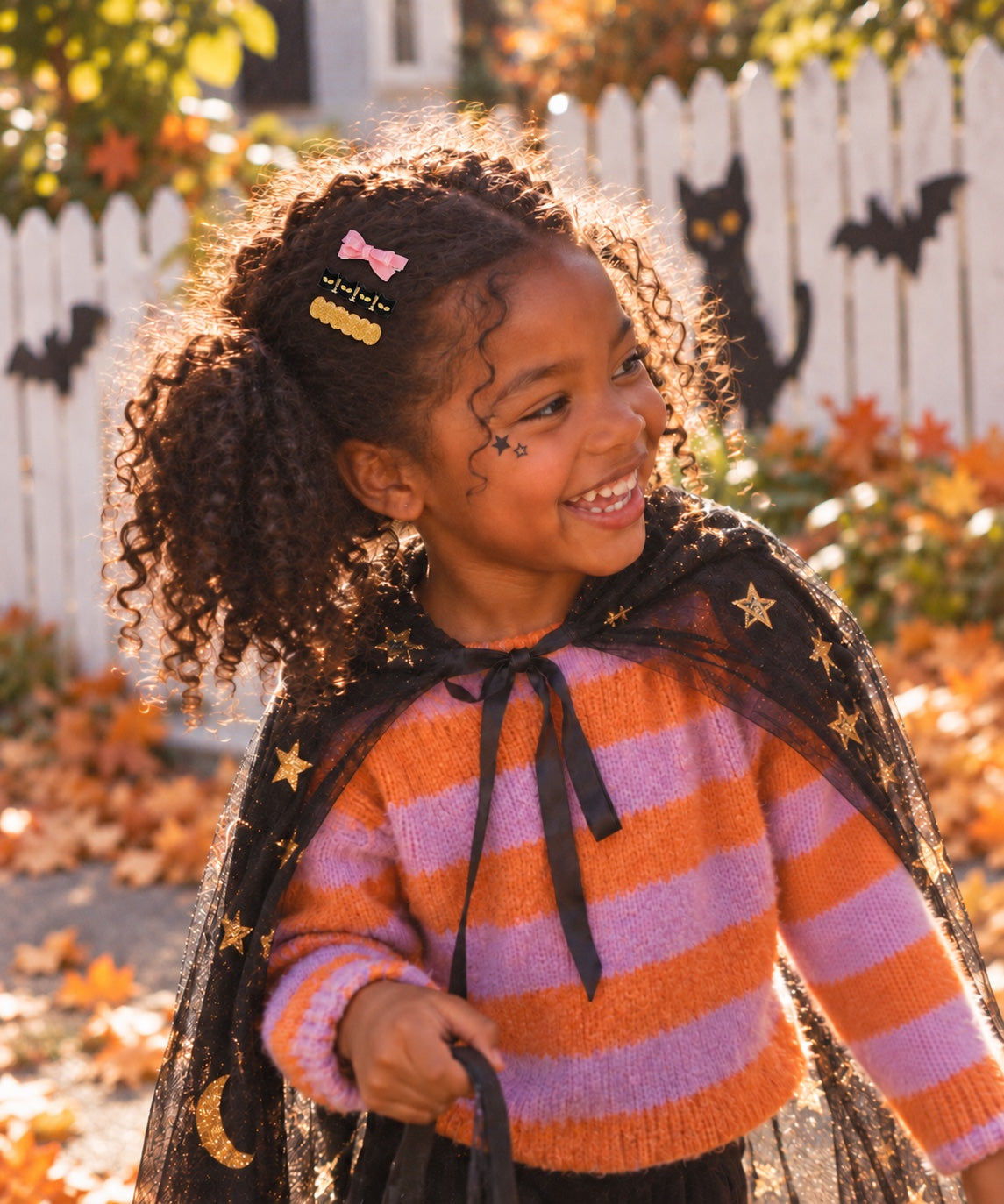 Child wearing Halloween hair clips outdoors